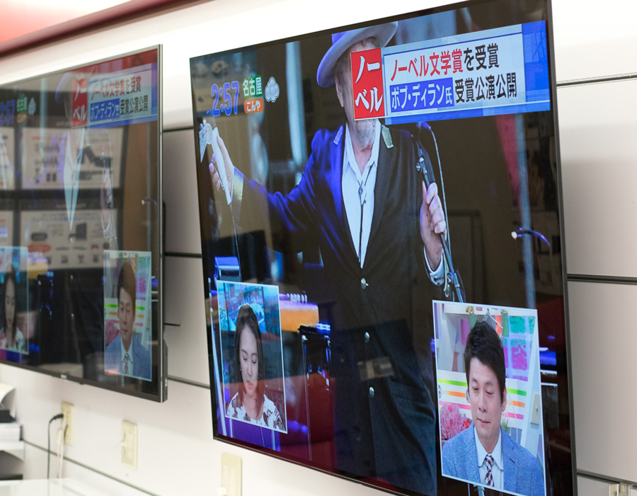 カトーデンキの店内で壁掛け展示されている有機ELテレビ