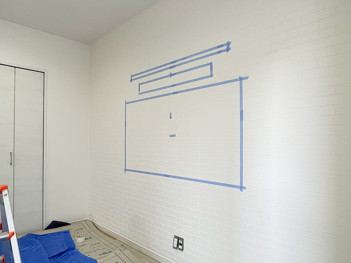 壁掛け工事中の一コマ。テレビとサウンドー、棚の位置決めが完了したところ。